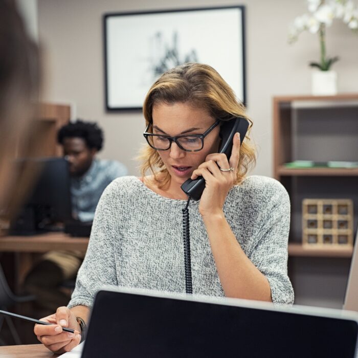 Businesswoman talking on phone at office